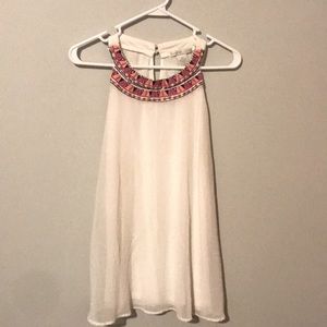 White sleeveless top with colors at the neckline